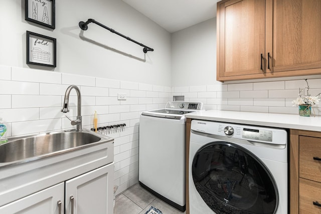 3N544 Bittersweet Rd, Saint Charles, IL 60175 - laundry area featuring cabinet space, washing machine and clothes dryer, light tile patterned floors, tile walls, and a wainscoted wall
