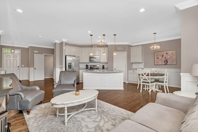 16127 W Switch Grass Rd, Lockport, IL 60441 - living area featuring dark wood-style floors, crown molding, a wainscoted wall, recessed lighting, and a decorative wall