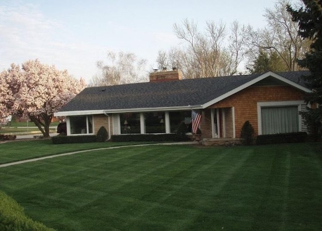 22 Greencroft Dr, Champaign, IL 61821 - rear view of property featuring a chimney, a yard, and roof with shingles