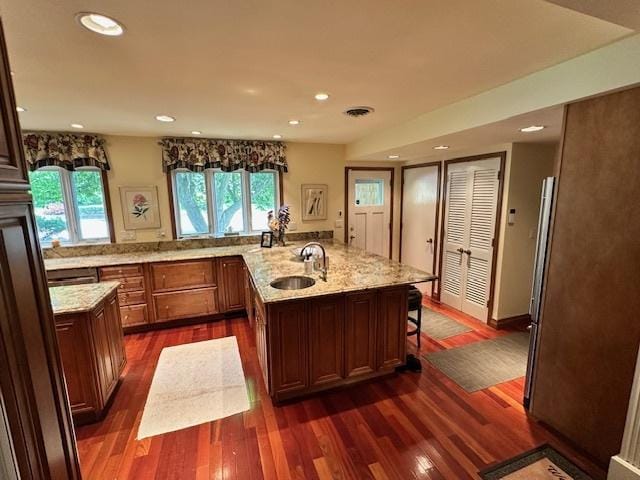 22 Greencroft Dr, Champaign, IL 61821 - kitchen featuring a sink, dark wood finished floors, a peninsula, recessed lighting, and light stone counters