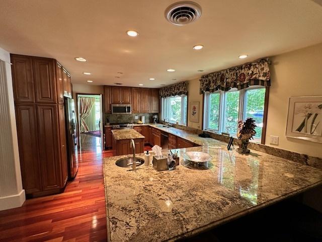 22 Greencroft Dr, Champaign, IL 61821 - kitchen with appliances with stainless steel finishes, a sink, recessed lighting, light stone countertops, and light wood-type flooring
