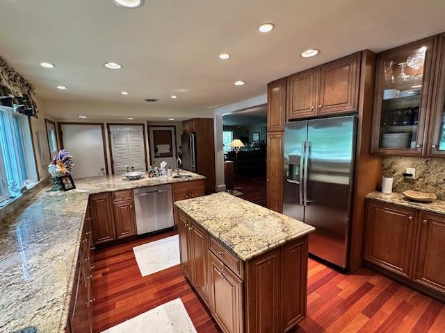 22 Greencroft Dr, Champaign, IL 61821 - kitchen featuring stainless steel appliances, dark wood finished floors, a center island, recessed lighting, and glass insert cabinets