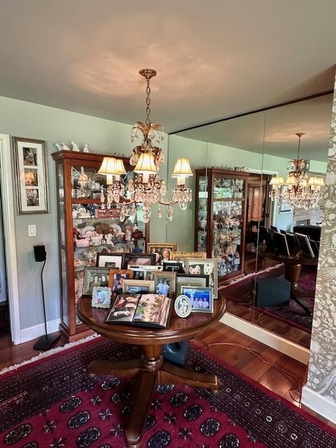 22 Greencroft Dr, Champaign, IL 61821 - dining space featuring a chandelier, wood finished floors, and baseboards