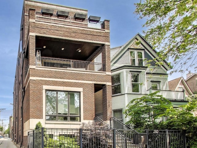 2745 N Greenview Ave Unit 2, Chicago, IL 60614 - view of front of house with a balcony, brick siding, and stairs