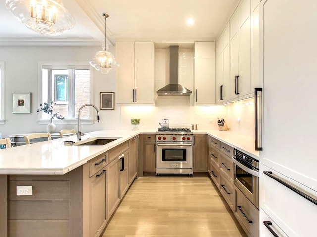 2745 N Greenview Ave Unit 2, Chicago, IL 60614 - kitchen with wall chimney exhaust hood, designer range, a sink, a peninsula, and light countertops