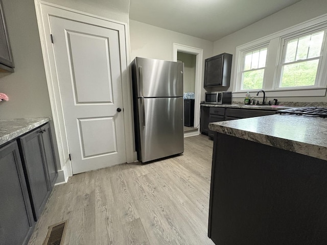 903 E Behrends Ave, Peoria, IL 61603 - kitchen featuring stainless steel appliances, light wood-type flooring, and a sink