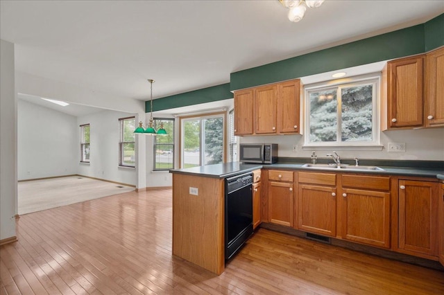 249 Spring Ct, North Aurora, IL 60542 - kitchen featuring black dishwasher, a peninsula, stainless steel microwave, dark countertops, and brown cabinetry