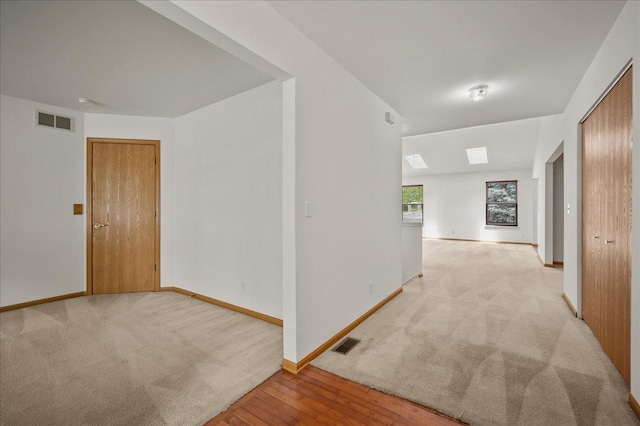 249 Spring Ct, North Aurora, IL 60542 - corridor featuring light colored carpet and light wood-style flooring