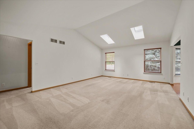 249 Spring Ct, North Aurora, IL 60542 - unfurnished room with a skylight, lofted ceiling, and light carpet