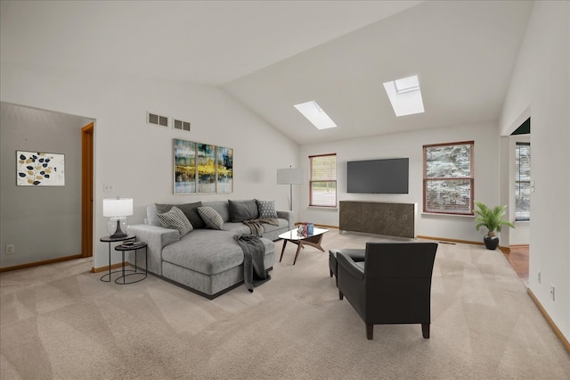 249 Spring Ct, North Aurora, IL 60542 - carpeted living room featuring a skylight and vaulted ceiling