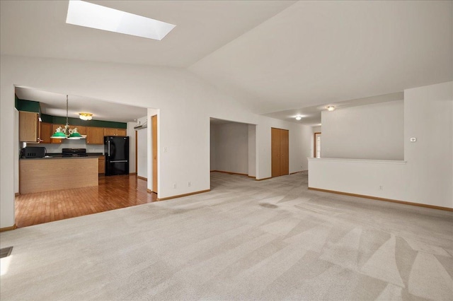 249 Spring Ct, North Aurora, IL 60542 - unfurnished living room featuring lofted ceiling, light colored carpet, and a skylight