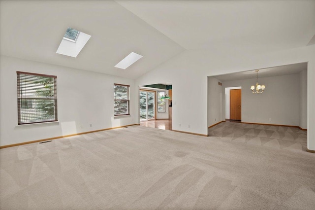 249 Spring Ct, North Aurora, IL 60542 - unfurnished room featuring light carpet, a chandelier, vaulted ceiling, and a skylight