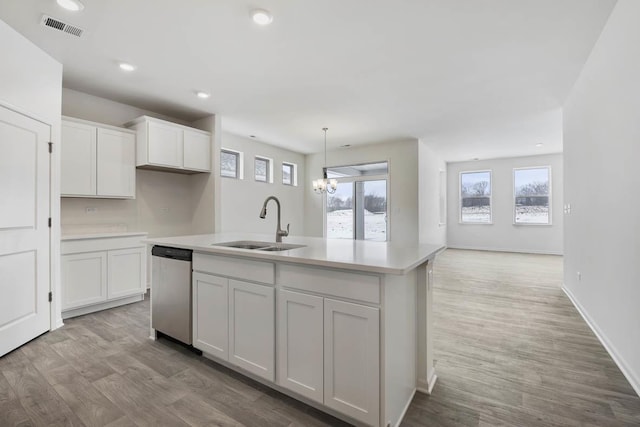 14657 S Greenbriar Dr, Plainfield, IL 60544 - kitchen with stainless steel dishwasher, a sink, white cabinets, an island with sink, and light countertops
