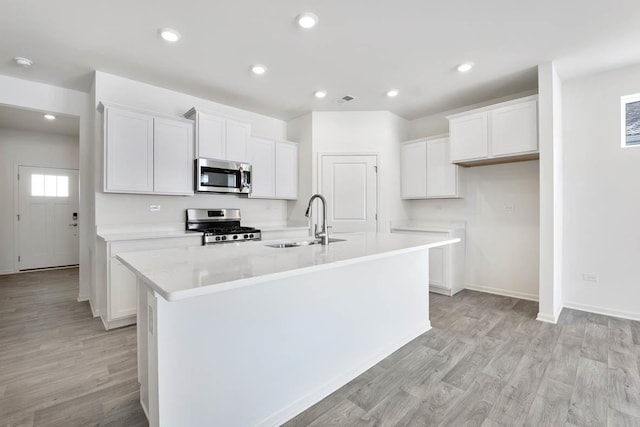 14657 S Greenbriar Dr, Plainfield, IL 60544 - kitchen with appliances with stainless steel finishes, a sink, a center island with sink, white cabinets, and light wood-style flooring