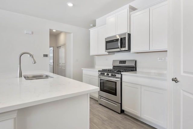 14657 S Greenbriar Dr, Plainfield, IL 60544 - kitchen with appliances with stainless steel finishes, a sink, light wood-type flooring, white cabinetry, and recessed lighting