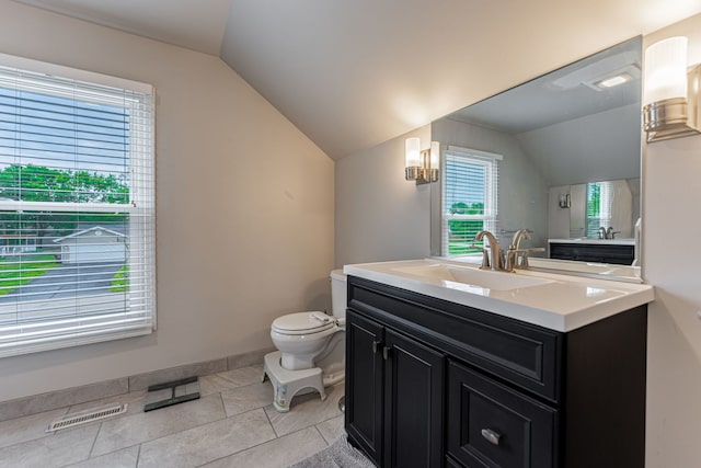 5724 Pierce Ln, South Beloit, IL 61080 - bathroom with lofted ceiling, toilet, vanity, tile patterned flooring, and baseboards
