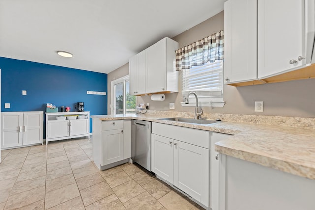 5724 Pierce Ln, South Beloit, IL 61080 - kitchen with stainless steel dishwasher, a sink, light countertops, white cabinetry, and light tile patterned floors