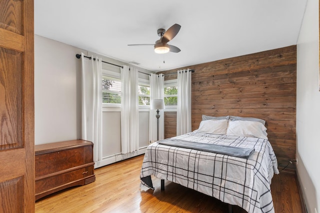 11111 Doogan Ave, Willow Springs, IL 60480 - bedroom with light wood-style floors, a ceiling fan, and a baseboard heating unit