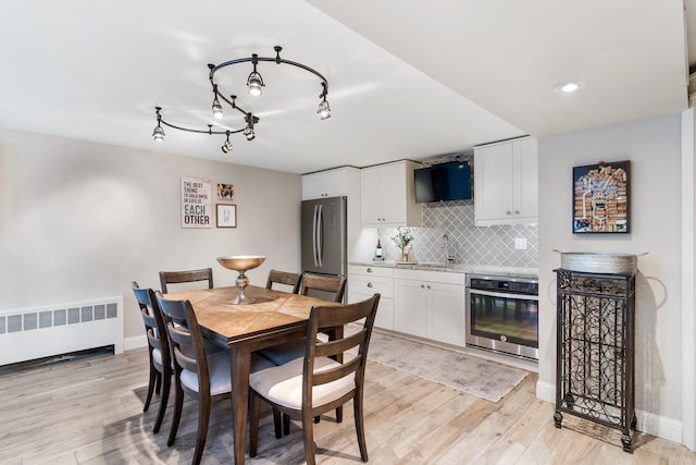 11111 Doogan Ave, Willow Springs, IL 60480 - dining space featuring radiator heating unit, light wood finished floors, and baseboards