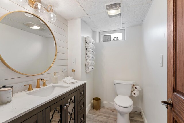 11111 Doogan Ave, Willow Springs, IL 60480 - half bathroom with vanity, toilet, wood finished floors, and a paneled ceiling