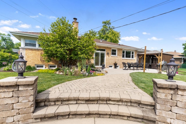 11111 Doogan Ave, Willow Springs, IL 60480 - rear view of house featuring a patio area, a chimney, brick siding, and a lawn