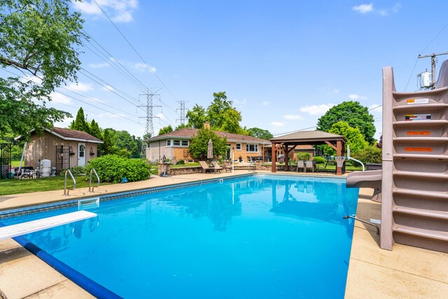 11111 Doogan Ave, Willow Springs, IL 60480 - view of swimming pool with a gazebo, a water slide, a diving board, an outbuilding, and a patio