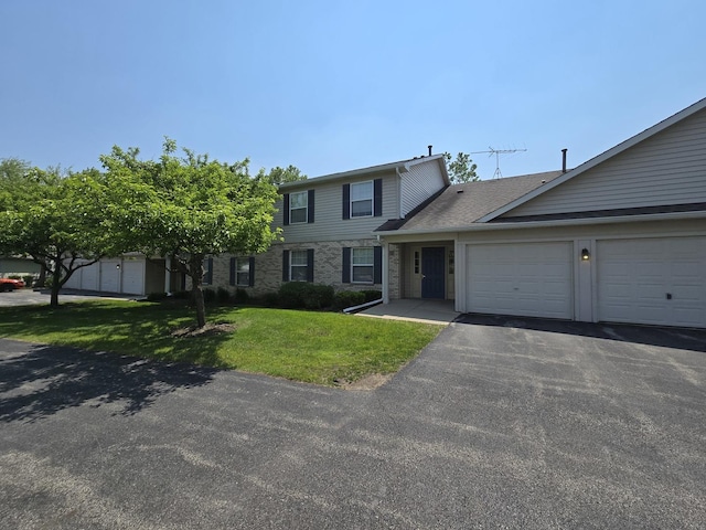 1075 N Village Dr Unit 4, Round Lake Beach, IL 60073 - view of front of property featuring a garage, a front yard, and asphalt driveway