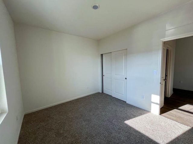 1097 Savannah Ln, Pingree Grove, IL 60140 - unfurnished bedroom featuring dark colored carpet, baseboards, and a closet