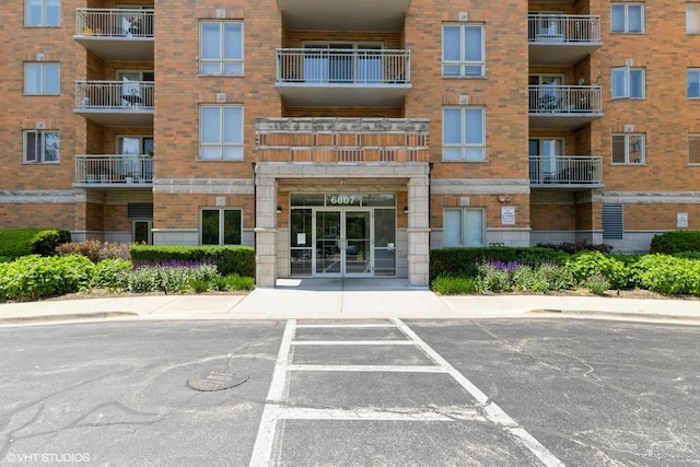 6807 N Milwaukee Ave Unit 303, Niles, IL 60714 - view of apartment building / complex with uncovered parking