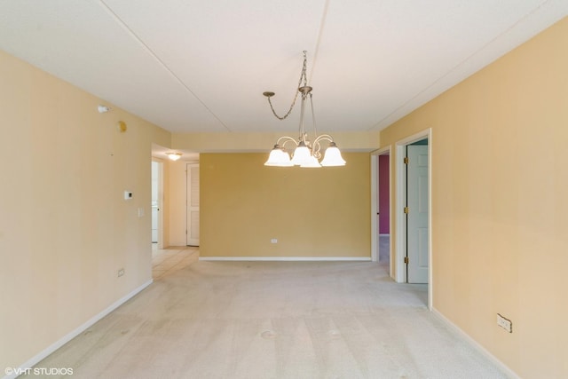 6807 N Milwaukee Ave Unit 303, Niles, IL 60714 - spare room with light carpet and a chandelier