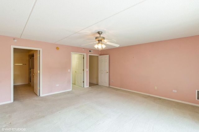 6807 N Milwaukee Ave Unit 303, Niles, IL 60714 - unfurnished bedroom featuring light carpet, connected bathroom, and a ceiling fan