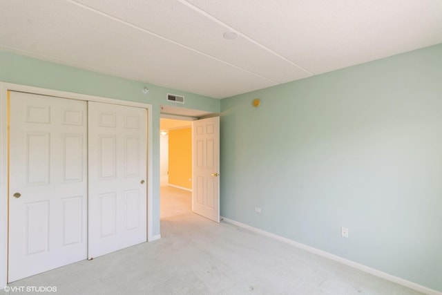 6807 N Milwaukee Ave Unit 303, Niles, IL 60714 - unfurnished bedroom featuring a closet and carpet floors
