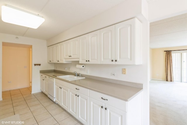 6807 N Milwaukee Ave Unit 303, Niles, IL 60714 - kitchen with white dishwasher, white cabinets, light tile patterned floors, and light countertops