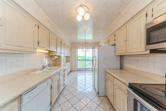 9500 N Washington St Unit 510, Niles, IL 60714 - kitchen featuring stainless steel appliances, a sink, tasteful backsplash, and light countertops