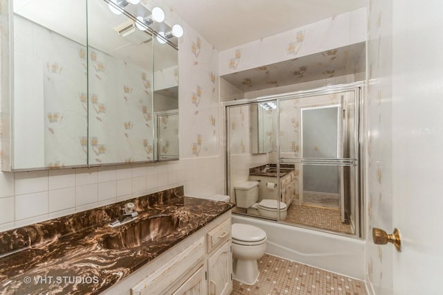 9500 N Washington St Unit 510, Niles, IL 60714 - bathroom with toilet, vanity, tile patterned flooring, and tile walls