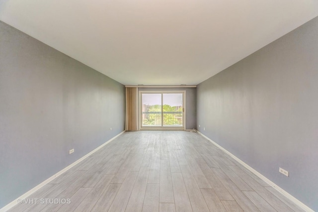 9500 N Washington St Unit 510, Niles, IL 60714 - spare room featuring light wood-style floors and baseboards