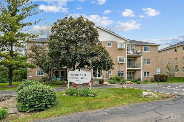 view of building exterior featuring uncovered parking