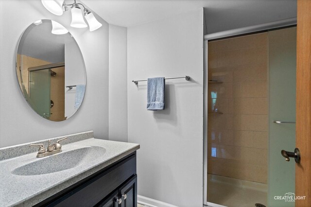 bathroom featuring a shower stall and vanity