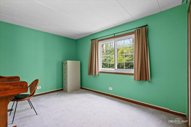 carpeted home office featuring baseboards