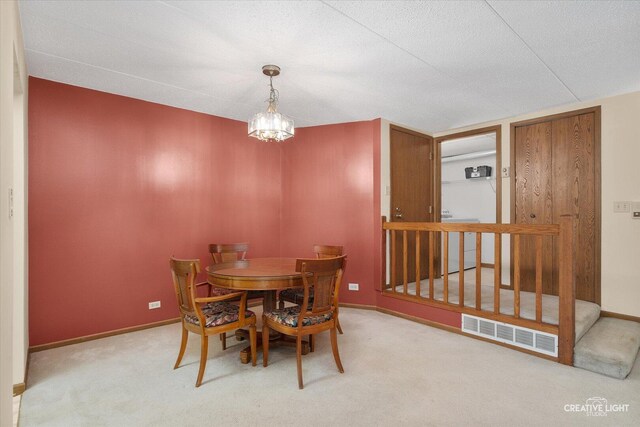 dining room with carpet flooring, baseboards, and a chandelier