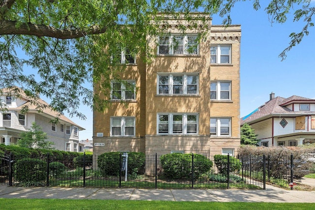 4860 W Warner Ave Unit 1, Chicago, IL 60641 - view of building exterior featuring a fenced front yard