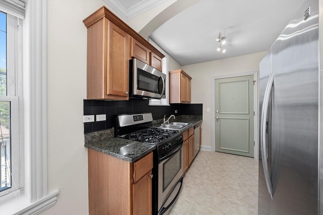 4860 W Warner Ave Unit 1, Chicago, IL 60641 - kitchen featuring stainless steel appliances, a sink, tasteful backsplash, brown cabinets, and light flooring