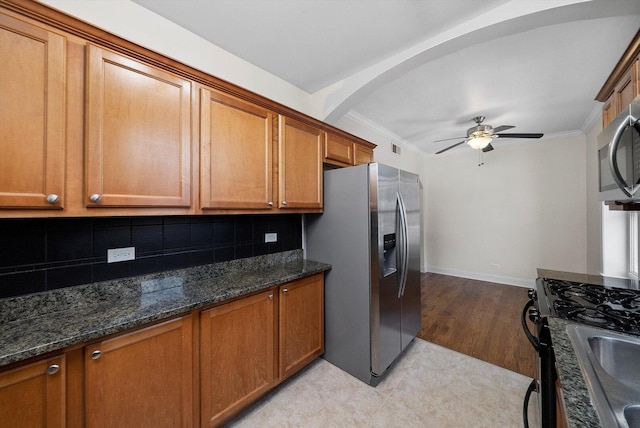 4860 W Warner Ave Unit 1, Chicago, IL 60641 - kitchen with stainless steel appliances, brown cabinets, ceiling fan, backsplash, and ornamental molding