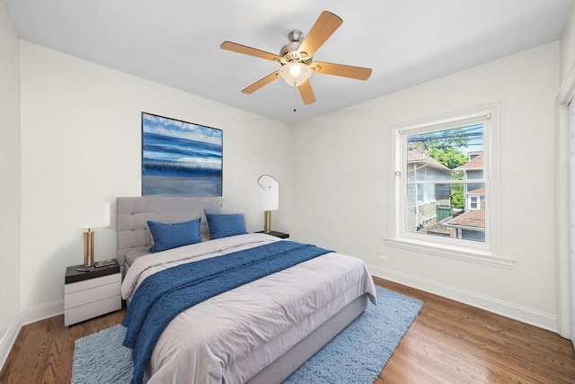4860 W Warner Ave Unit 1, Chicago, IL 60641 - bedroom featuring baseboards, wood finished floors, and a ceiling fan