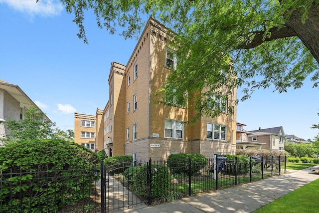 4860 W Warner Ave Unit 1, Chicago, IL 60641 - view of building exterior featuring a fenced front yard