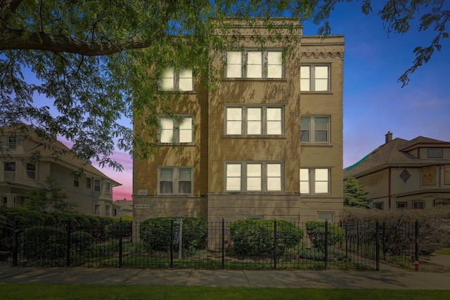 4860 W Warner Ave Unit 1, Chicago, IL 60641 - property at dusk featuring a fenced front yard