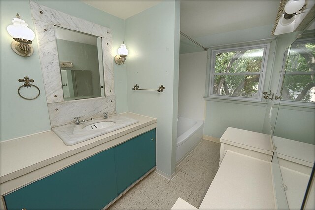 610 E Main St, Ottawa, IL 61350 - full bath with vanity, baseboards, and shower / washtub combination