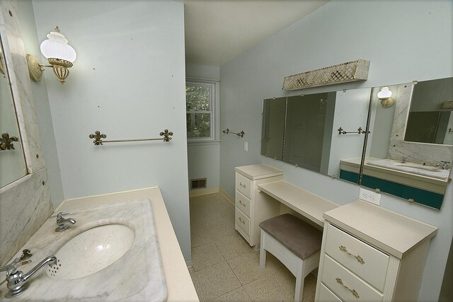 610 E Main St, Ottawa, IL 61350 - full bath with vanity, lofted ceiling, tile patterned floors, and baseboards