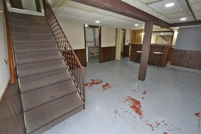 610 E Main St, Ottawa, IL 61350 - finished below grade area featuring stairway, a dry bar, wooden walls, and wainscoting
