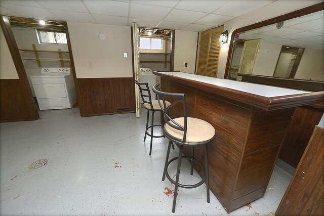 610 E Main St, Ottawa, IL 61350 - indoor dry bar with washer / clothes dryer, a drop ceiling, a wainscoted wall, and wooden walls